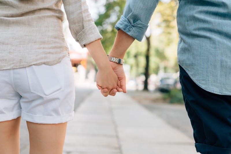 couple holding hands talking about how to live with your partner