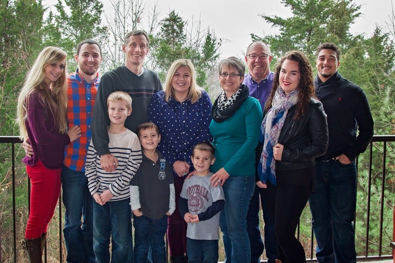 family posing together with trees in background talking about intruding questions