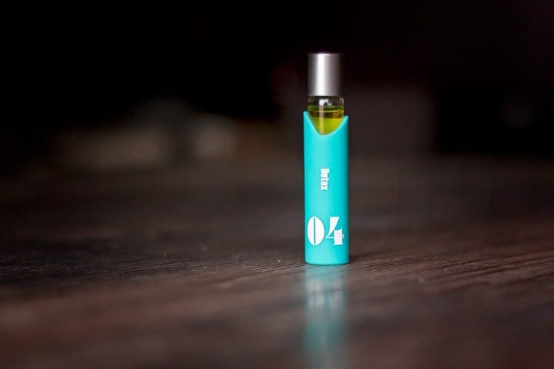 bottle of essential oils on hardwood floor used to stay fresh