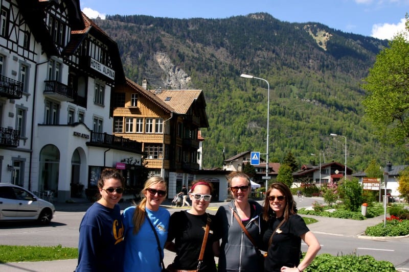 friends standing in front of hostel showing why you should travel when you're young