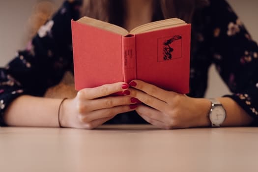 Pexels person reading book with red cover