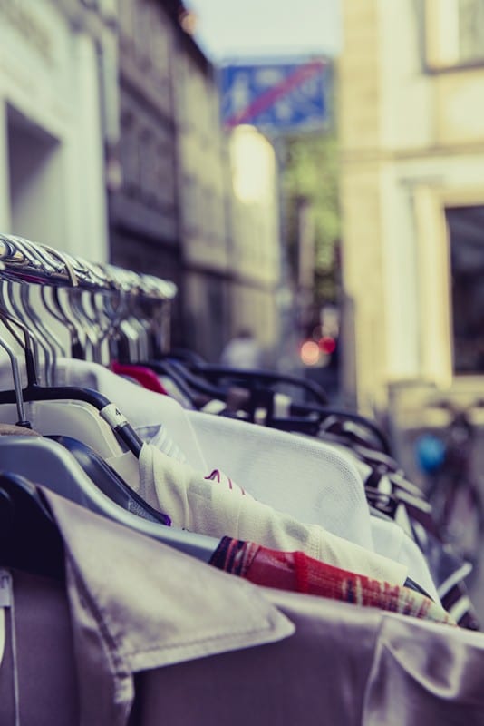clothes on hangers hanging on clothing rod for capsule wardrobe