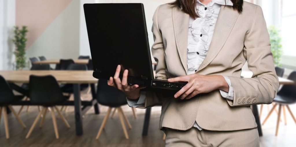 businesswoman holding laptop