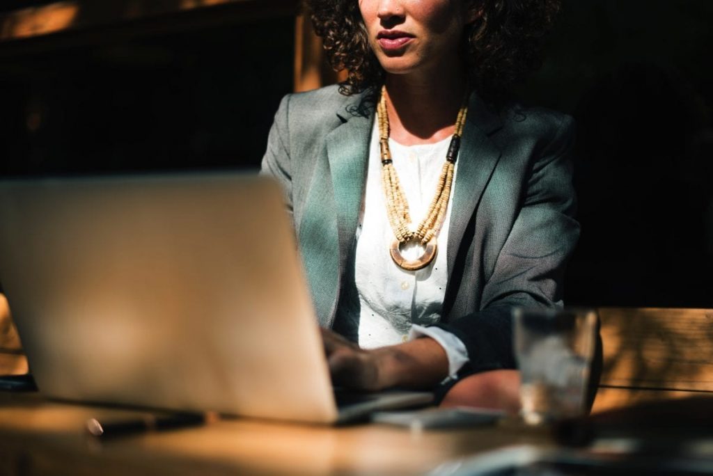businesswoman working on laptop outdoors