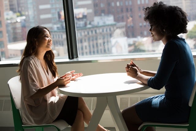 women talking by window