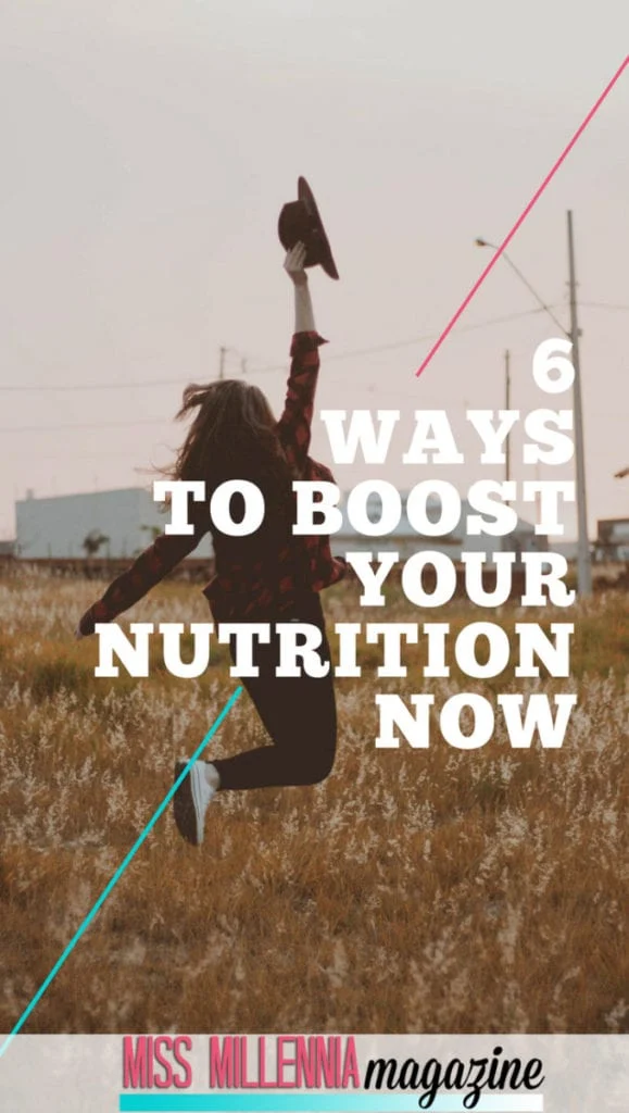 a woman jumping in the air with a hat