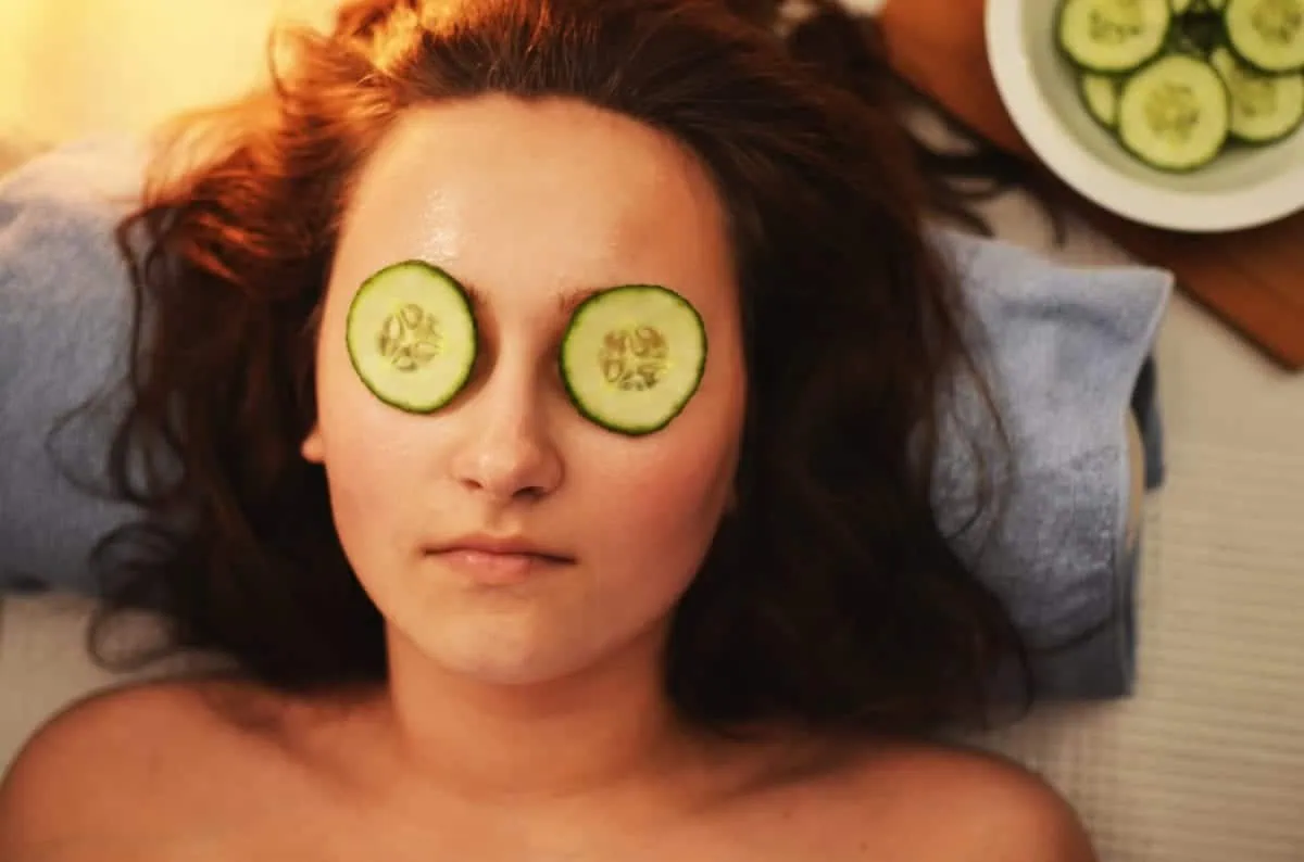 woman with cucumbers on her eyes