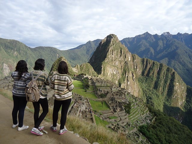 three girls standing at Macchu Picchu