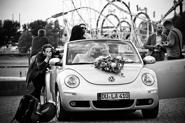Image by Michael Gaida from Pixabay wedding photographer taking picture of couple just married in car