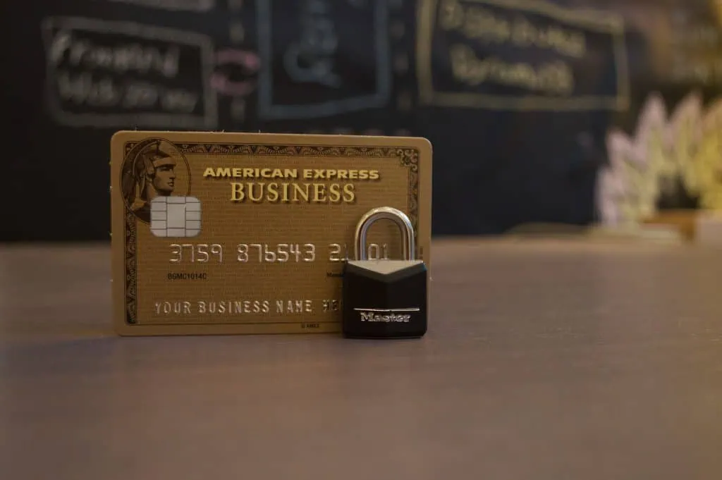 An american express business card with a lock in front of it