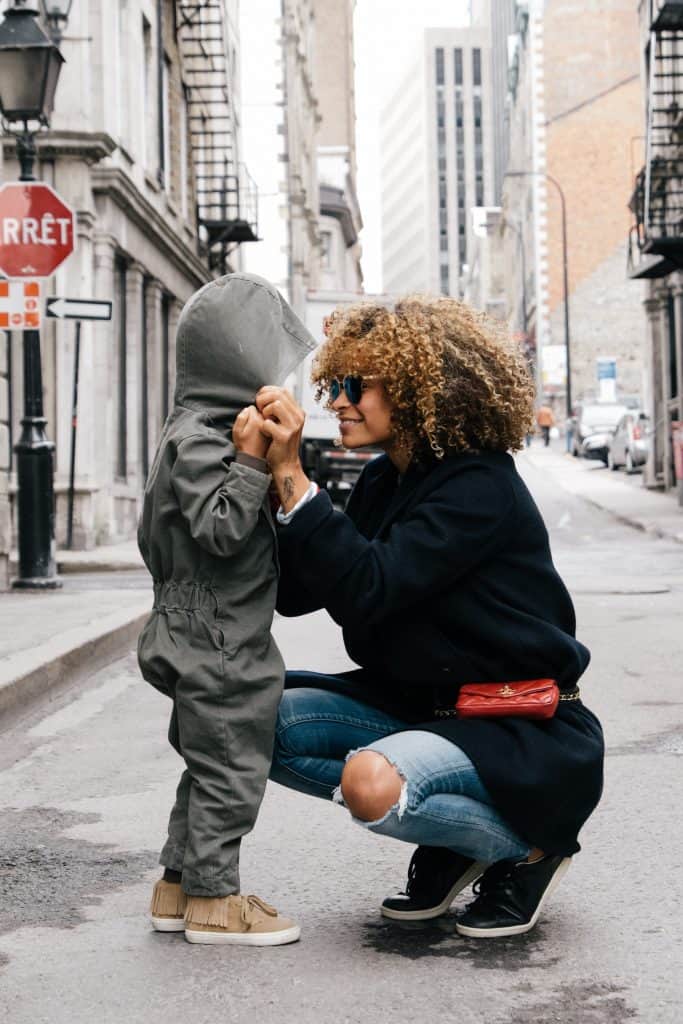 A mom and son smiling in the street