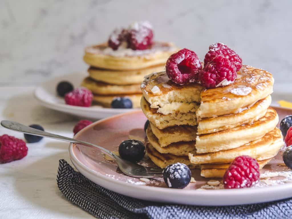 A stack of pancakes topped with berries