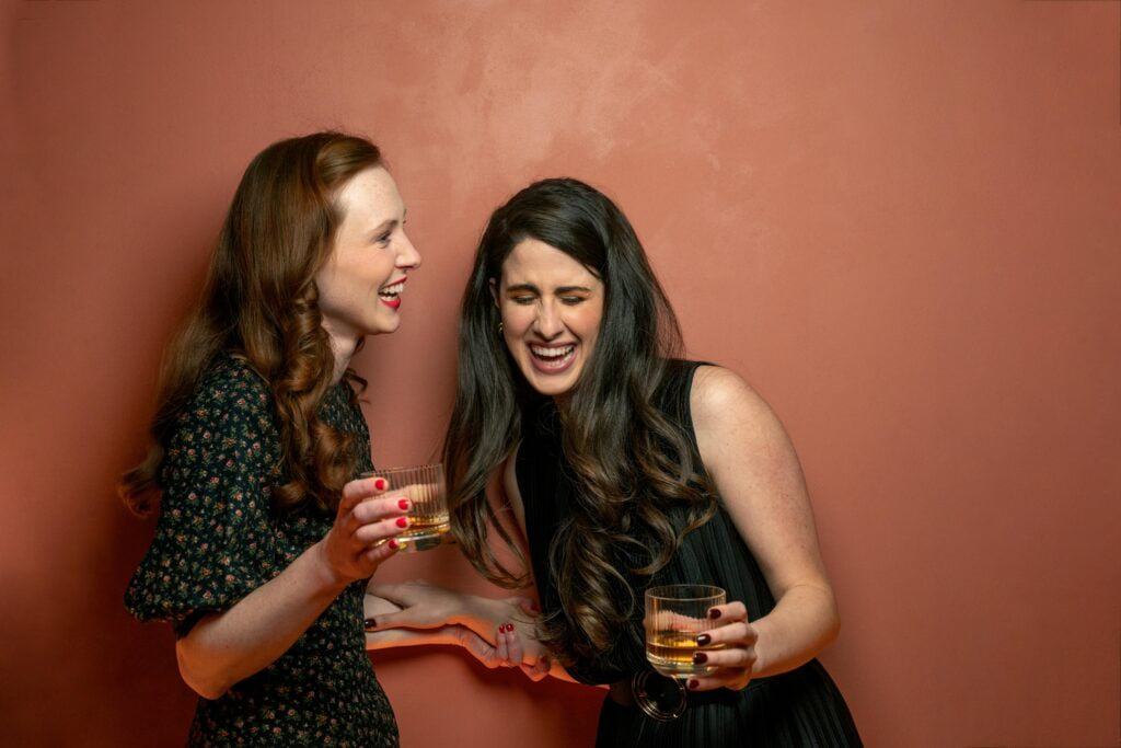 women laughing with drinks
