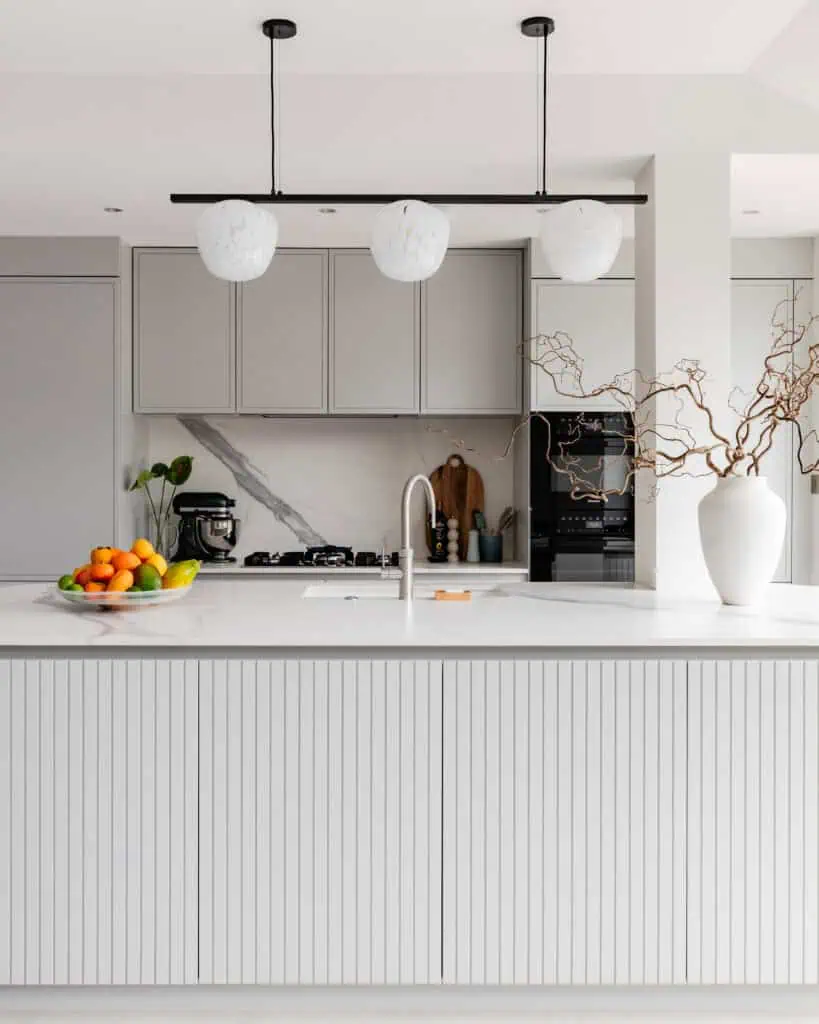 Contemporary Victorian kitchen with sleek cabinetry and minimalist decor in Chiswick Highroad refurb.