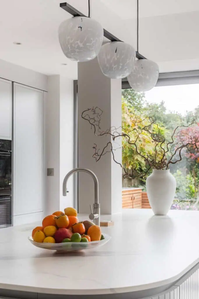 Contemporary Victorian kitchen with minimalist design and elegant lighting fixtures.