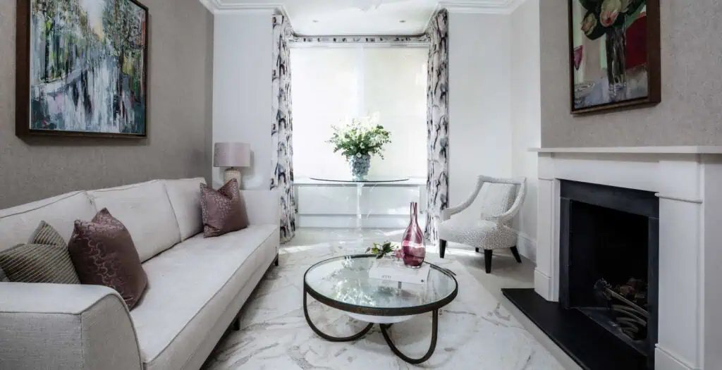 Elegant Victorian living room with modern interior design, white walls, and decorative artwork.