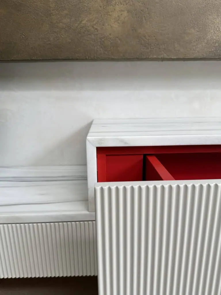 Bespoke wall unit with ribbed white finish in a contemporary family home.