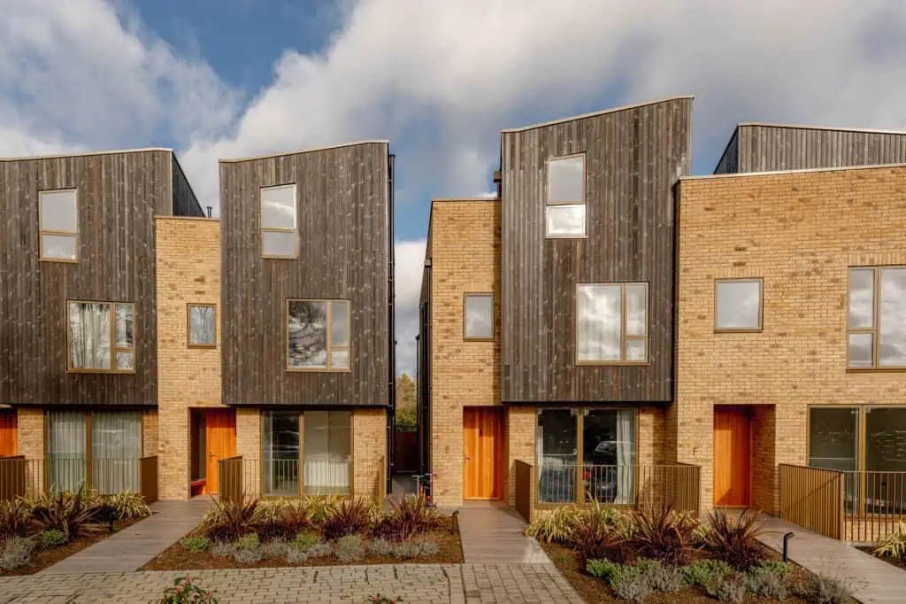 Modern residential townhouses in Wimbledon with sleek design and natural materials.