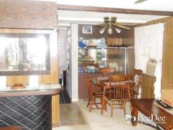 Fleetwood Broadmore Single Wide - Original Living Room and Dining Room Design Example 3 - Original unpainted paneling - Favorite Classic Mobile Home Models of Mobile Home Experts