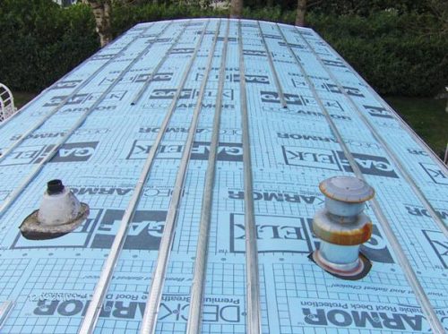 MOBILE HOME ROOF OVER - COVERED IN DECKARMOUR AND THEN METAL HAT TRACK APPROXIMATELY 16 INCHES APART