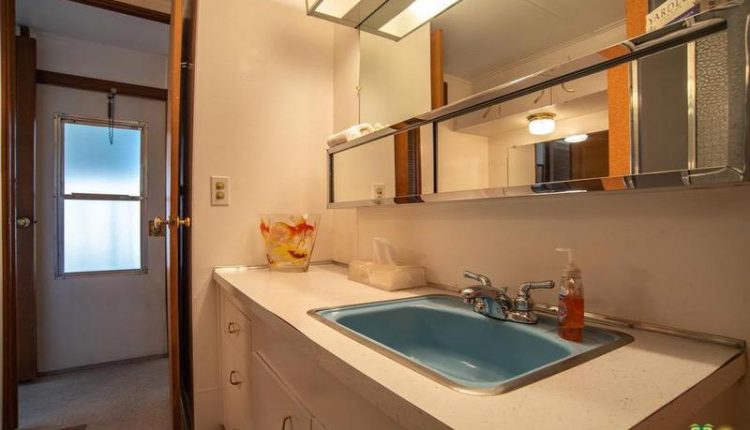 1962 Skyline is a Vintage Mobile Home Beauty - master bathroom with teal sink