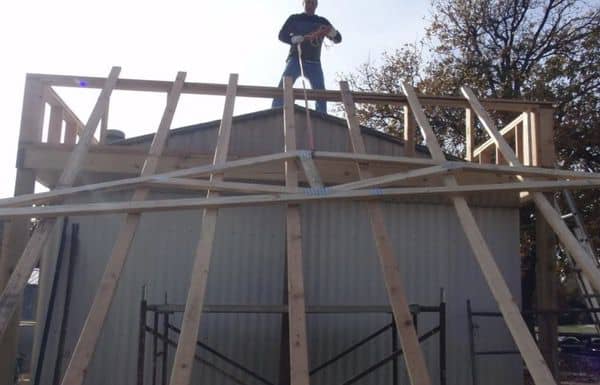 a hoist system to get the trusses on top of the roof
