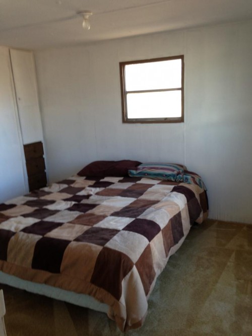 bedroom back wall before mobile home renovation - rustic style