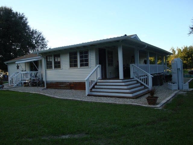 double wide manufactured home with wrap around porch
