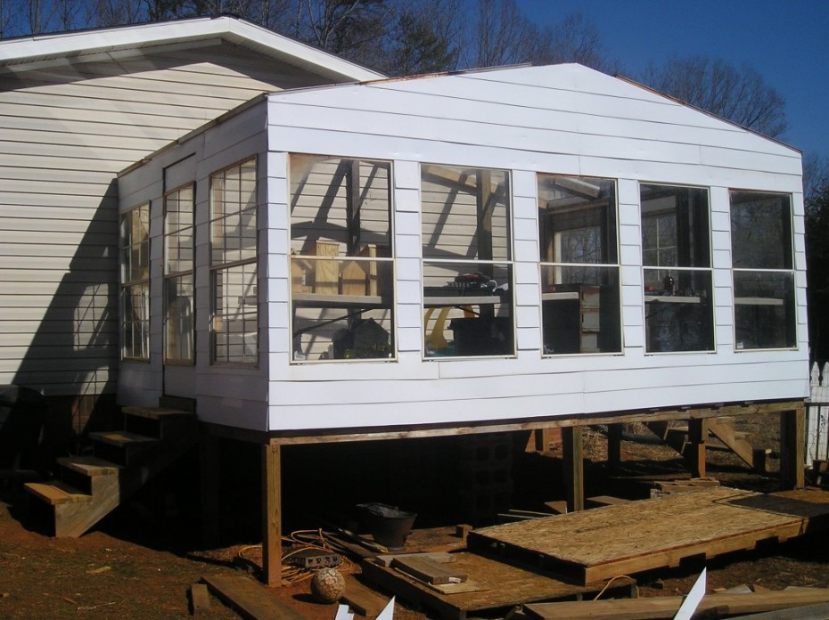 greenhouse built onto a manufactured home for homesteading