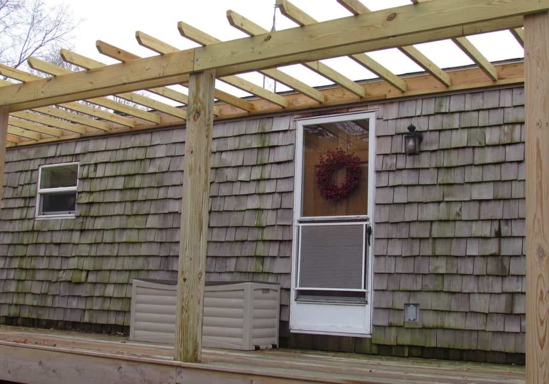 mobile home lake house with cedar siding and huge covered porch the whim00001