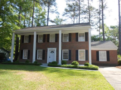 two story brick house with columns 