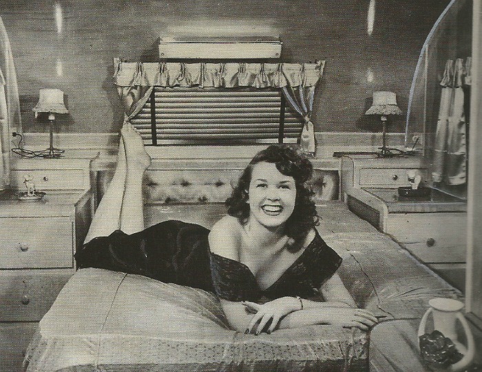 happy woman on camper bed