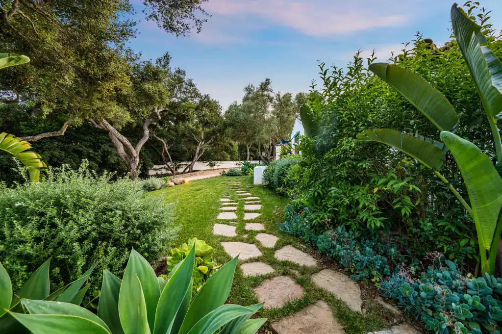 An Outside Walkway That Leads To A Lush Green Yard 2026 01 07 07 24 13 Utc