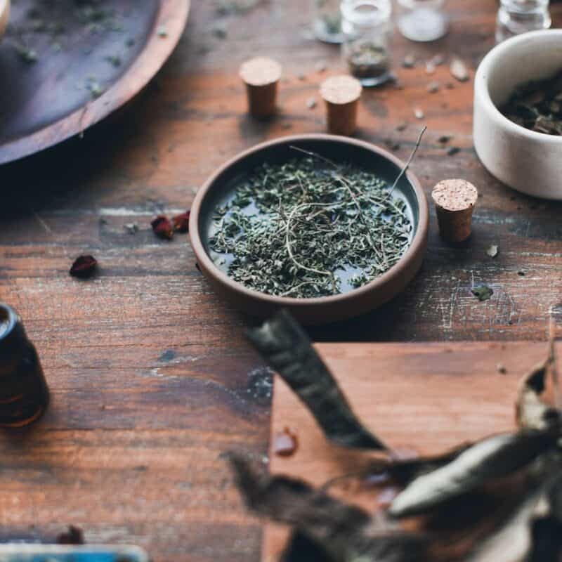 round brown wooden table with four chairs