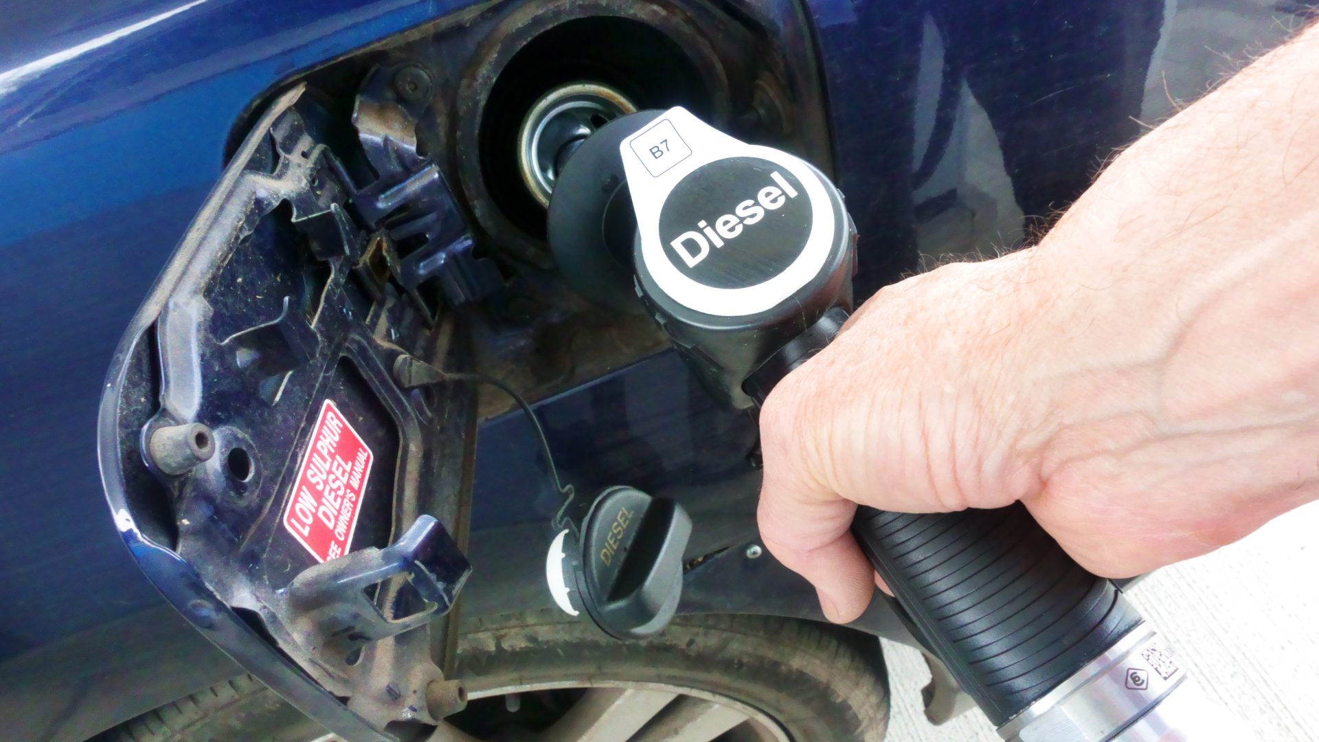 Diesel being pumped into car at petrol station