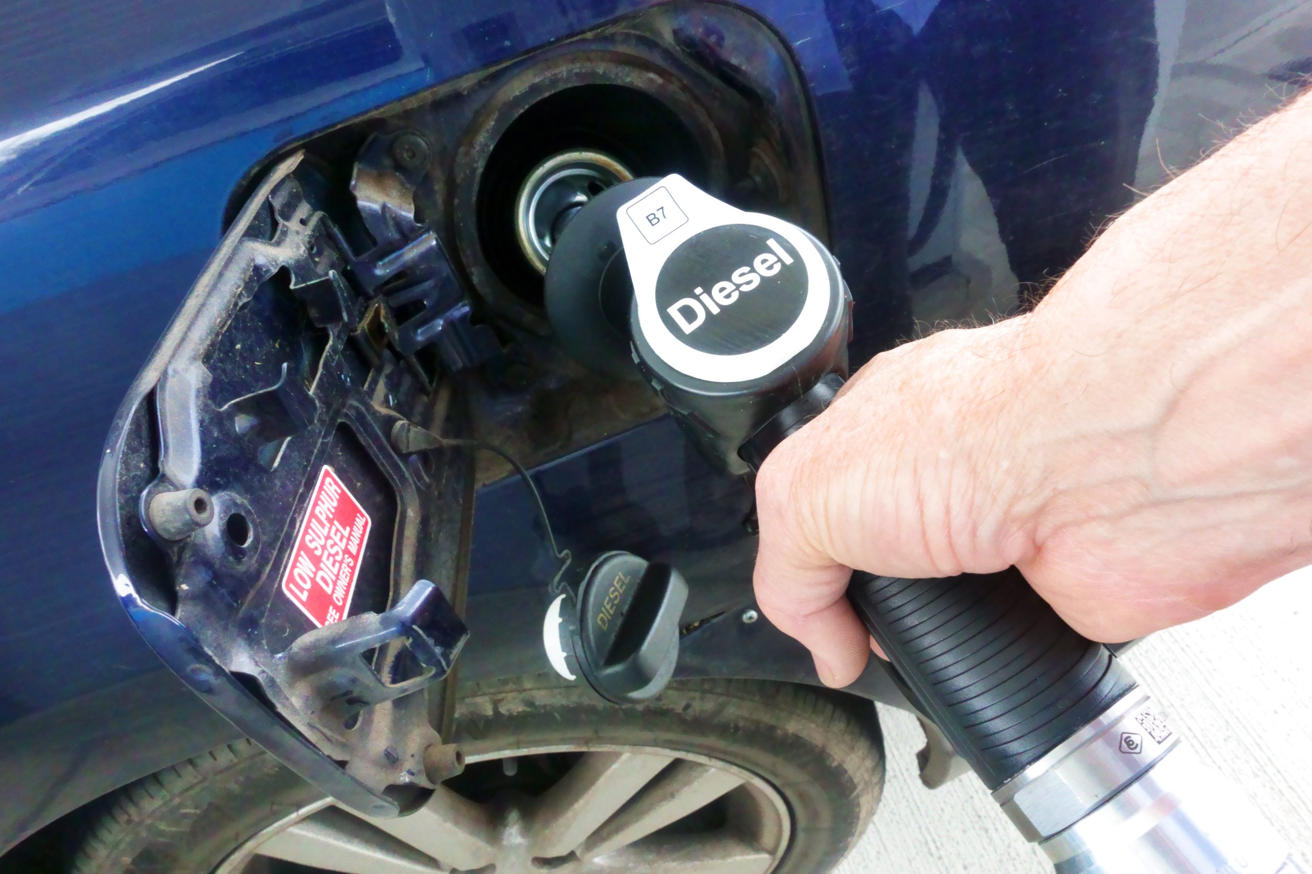 Diesel being pumped into car at petrol station