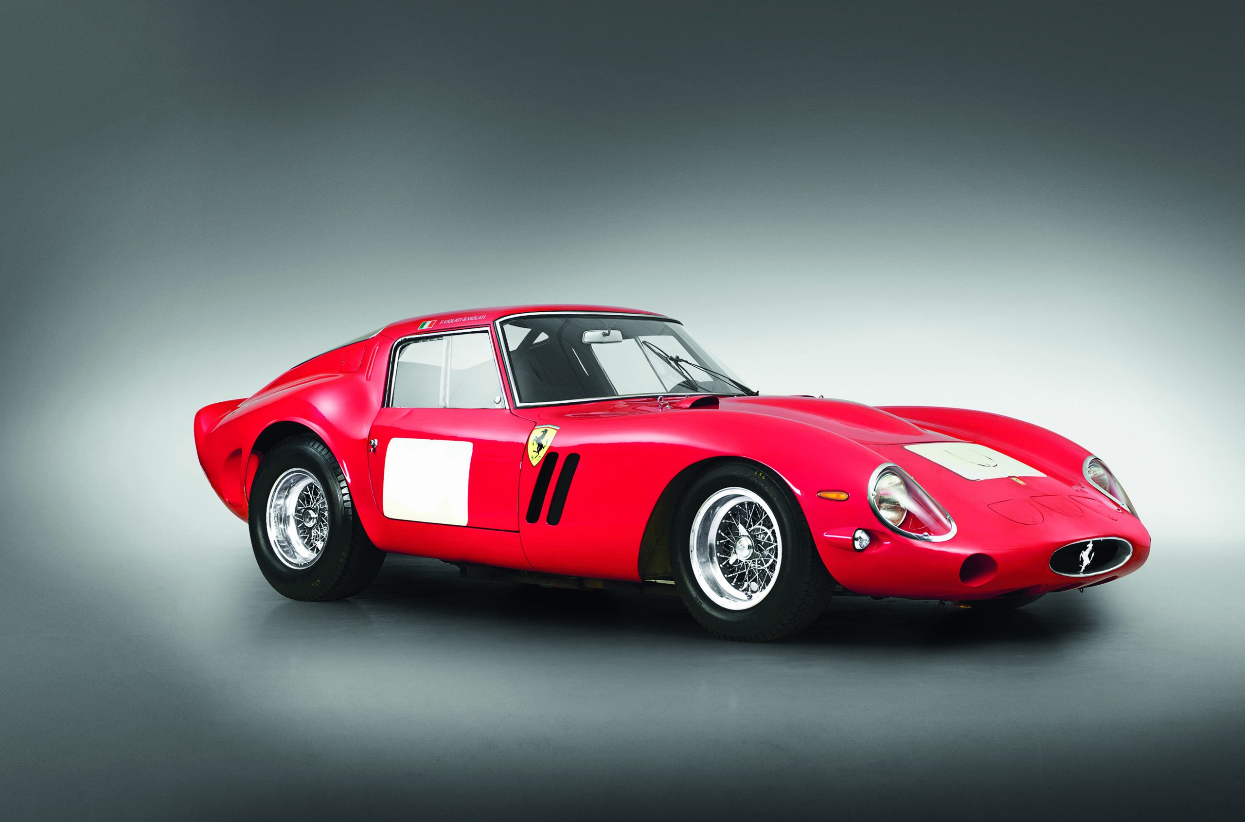 #2 - The 1962 250 GTO is Ferrari’s crown jewel—race-bred, road-legal perfection. Its 3.0-litre (2,953 cc) Tipo 168/62 Colombo V12, front-mounted, delivered 300 bhp at 7,400 rpm and 294 Nm at 5,500 rpm via six Weber 38 DCN carburettors. Bore/stroke of 73 mm x 58.8 mm, 9.2:1 compression, it hit 0-60 mph in 5.4 seconds and 174 mph. The steel tubular chassis, with aluminium panels, weighed 950 kg dry, on a 2,400 mm wheelbase. Live rear axle with semi-elliptic springs, front double wishbones, and 185 VR15 Dunlops balanced it. Its genius? Homologation for GT racing—winning three world titles (1962-1964)—with a hand-built Pininfarina body by Scaglietti, each of 36 units unique. The dry-sump V12, five-speed manual, and aerodynamic curves—tested in a wind tunnel—made it a track dominator and street rarity, fetching $70 million in 2018.