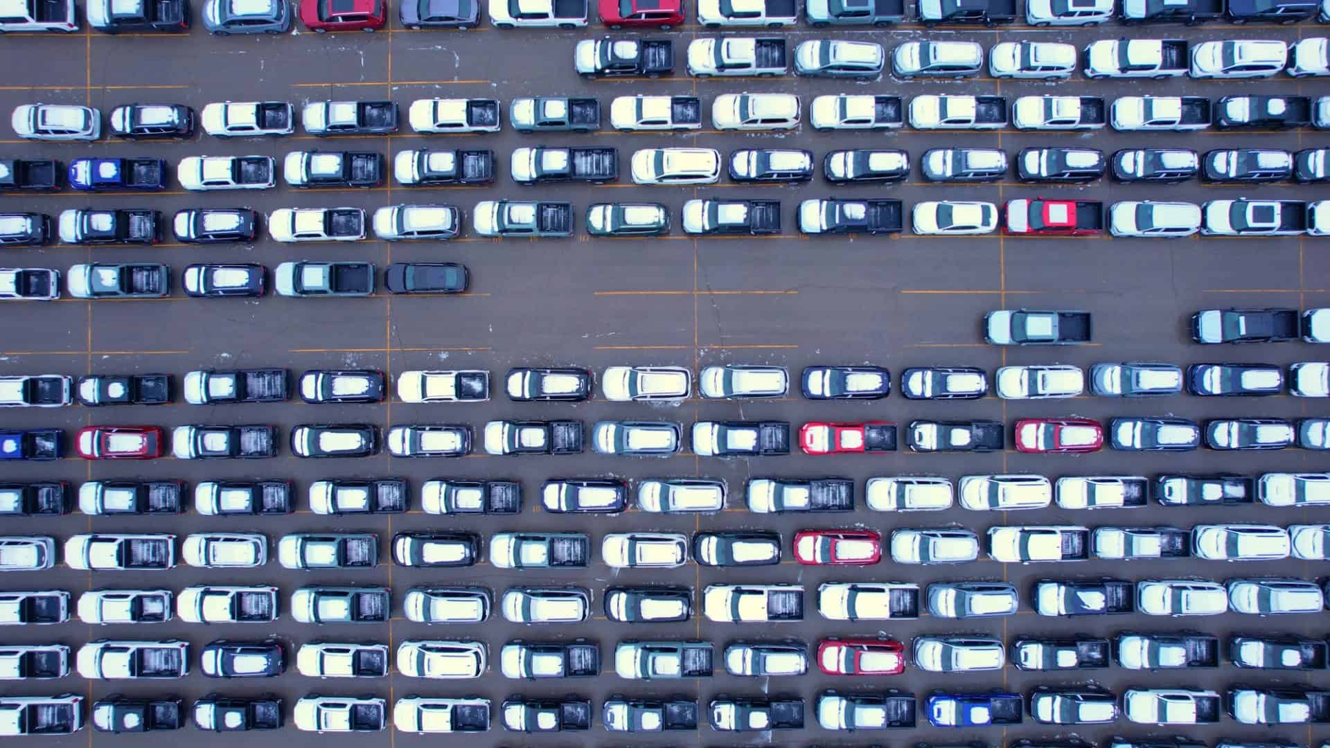 Aerial view of car storage or parking lot with new and used vehicles for export to USA and Internationally. Vehicle transportation facility, waiting to pass customs, duties licenses and permits.
