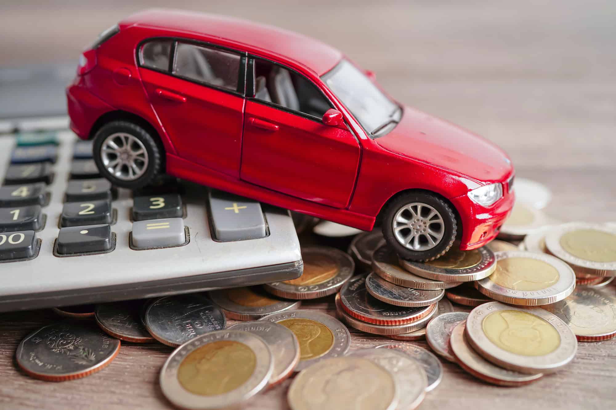 Car on coins and calculator Car loan, Finance, saving money, insurance and leasing time concept.