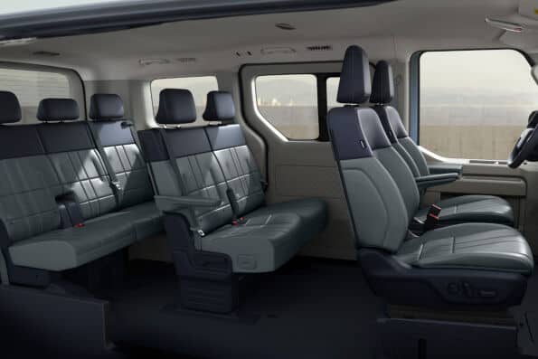 Kia PV5 Passenger 7-seat rear three-quarter view with sliding door