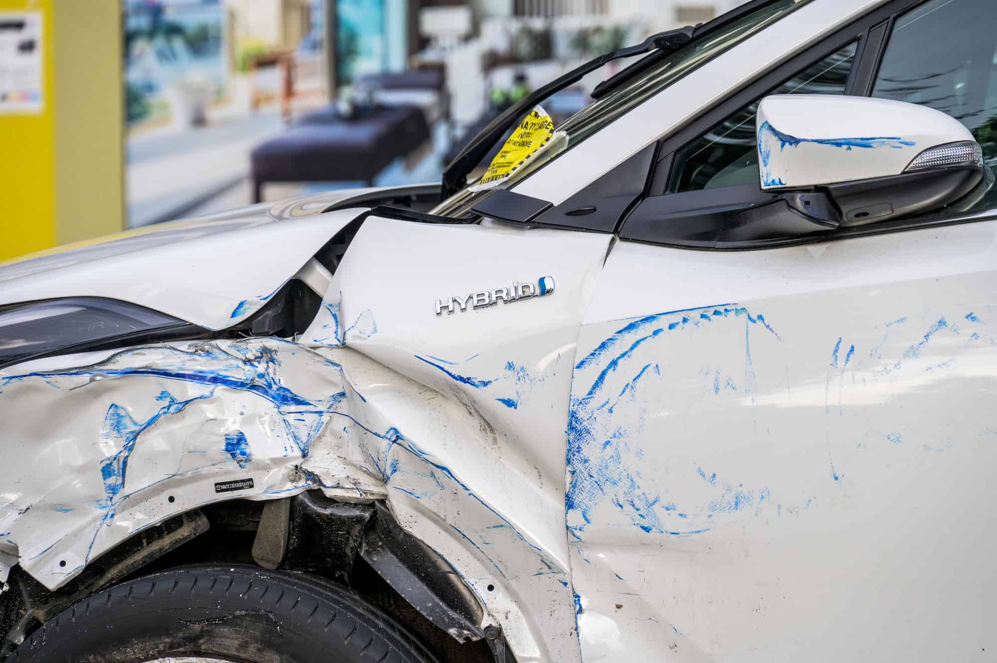 LONDON - May 21, 2022: Close up of damaged white hybrid car at side of road. Penalty Charge Notice parking fine attached to windscreen — Stock Editorial Photography