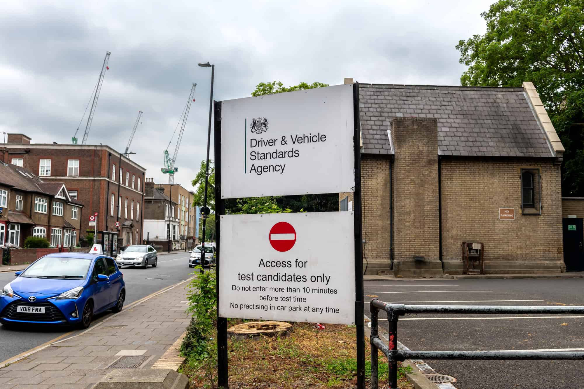 London. UK- May 04. 2026. The Driver and Vehicle Standards Agency sign by the entrance to a driving test centre with the building in the background. — Photo by MingPhoto
