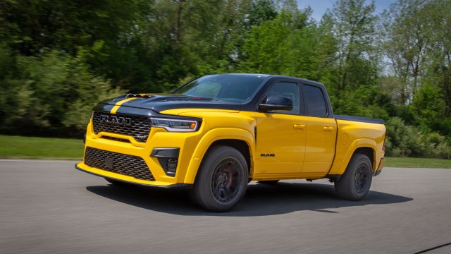 Yellow and black Ram 1500 Rumble Bee SRT muscle truck driving on a road course