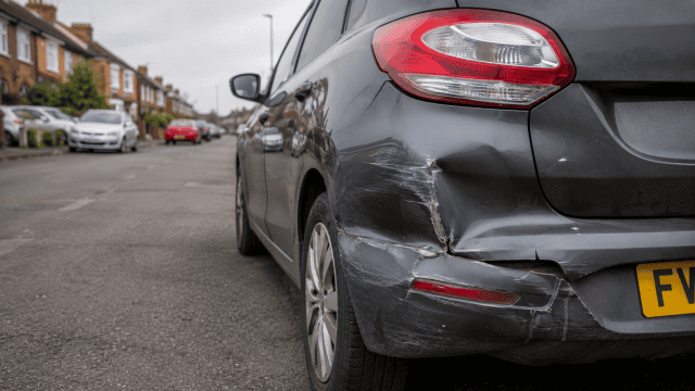 Close up of a damaged Hatchback on a Suburban Street. minor damage.