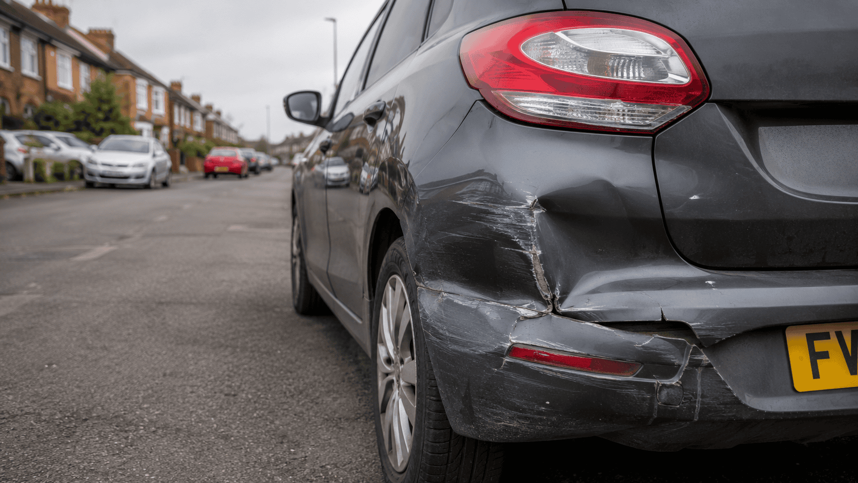 Close up of a damaged Hatchback on a Suburban Street. minor damage.