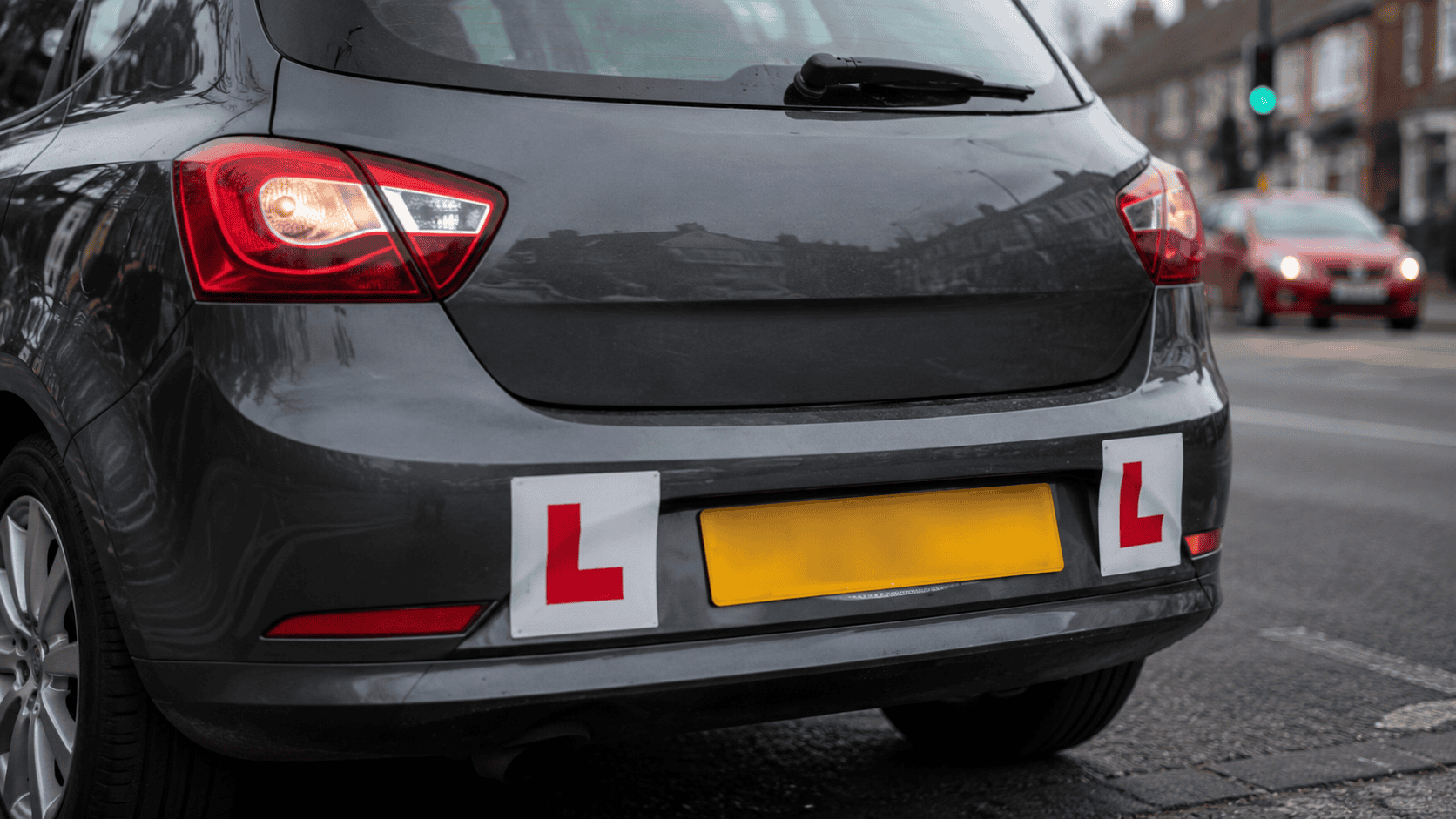 Learner Hatchback on a Wet Street