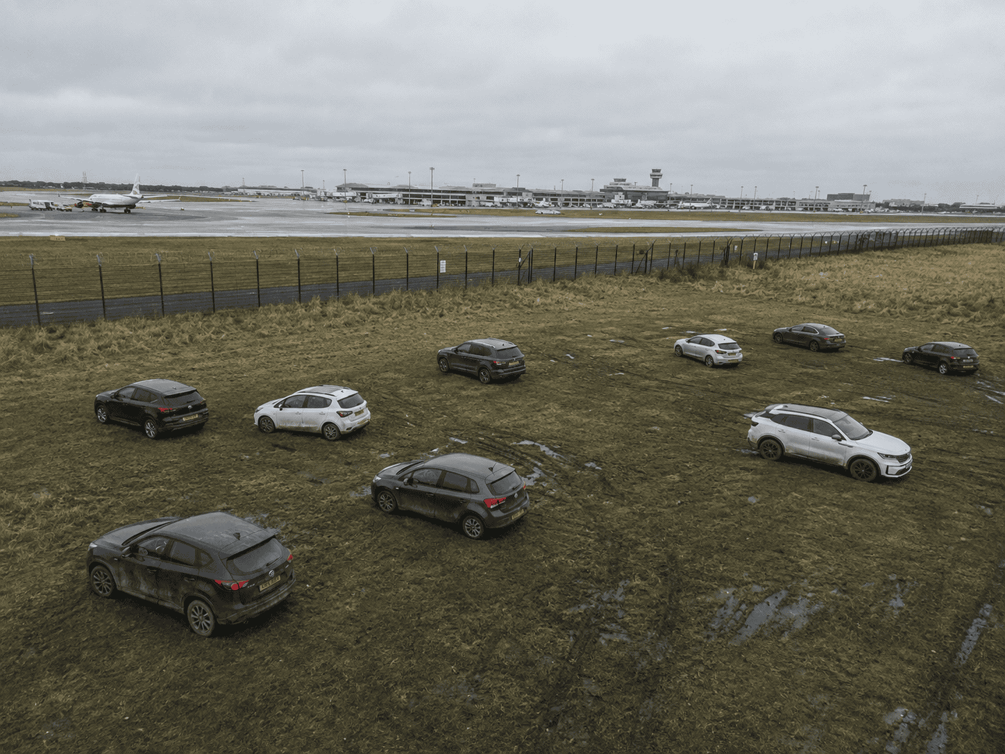 Cars left in muddy field at airport