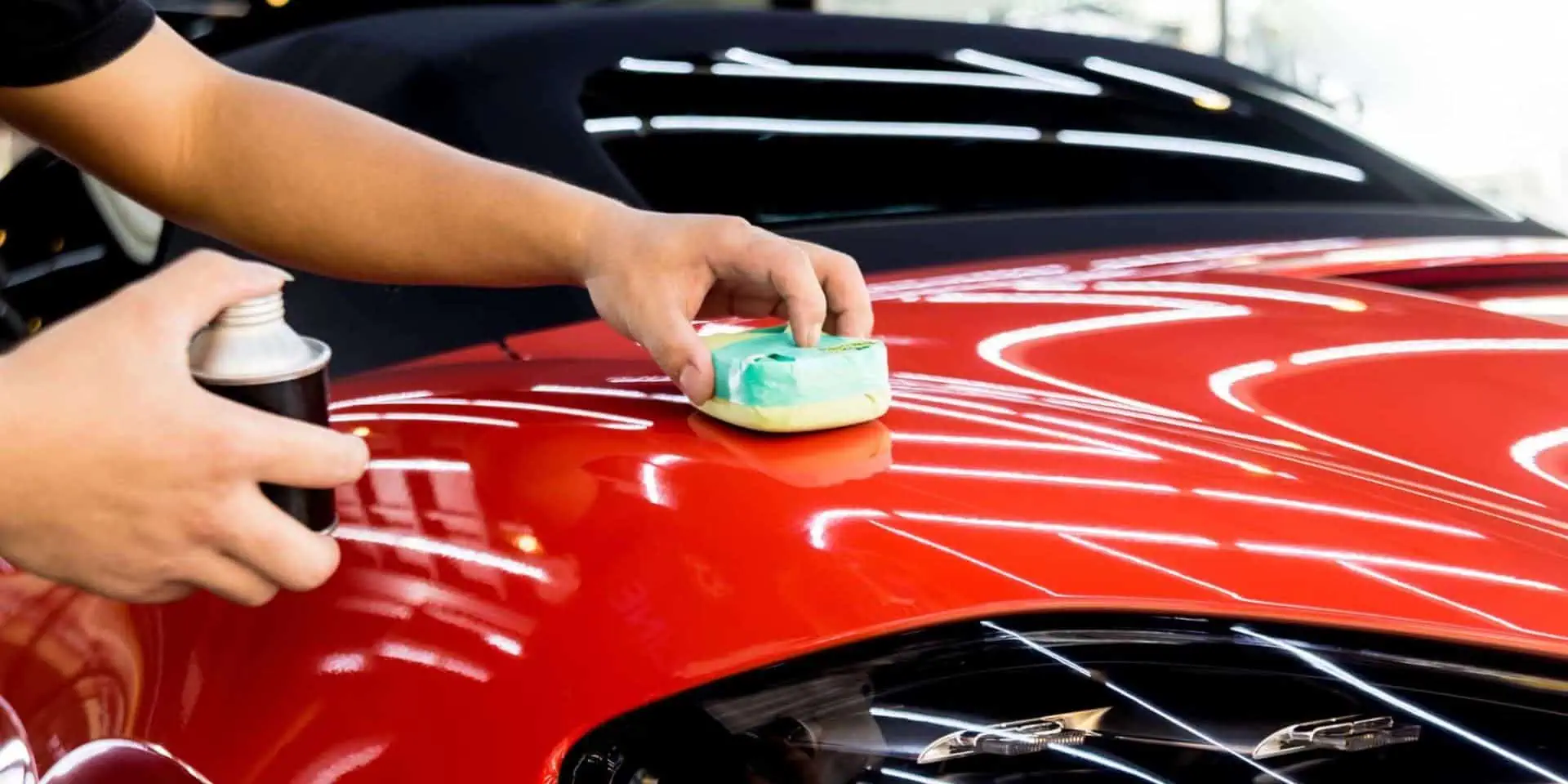 Car service worker applying nano coating on a car detail