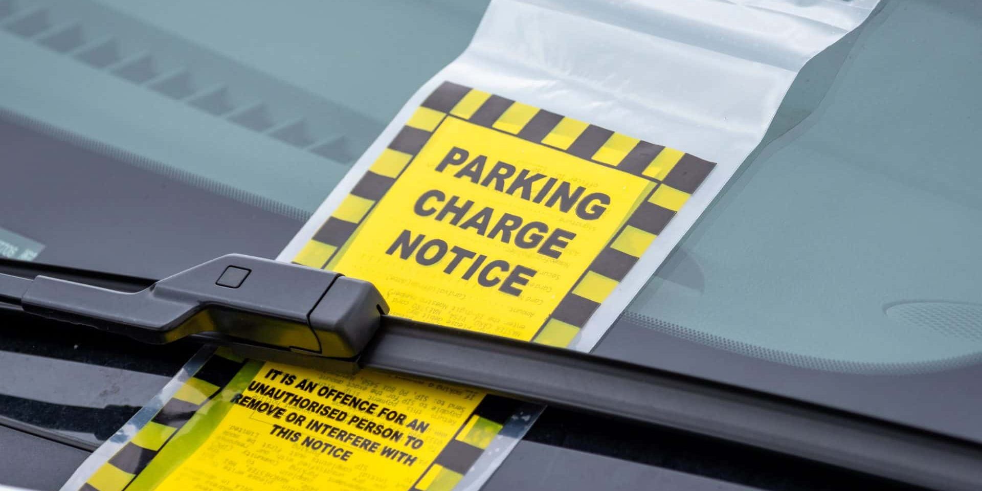 Parking ticket under wind screen wiper of a car