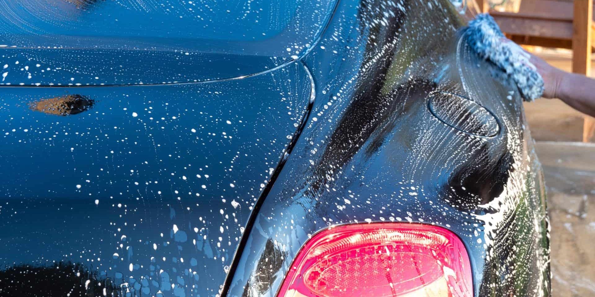 Car detailer washing auto with soap